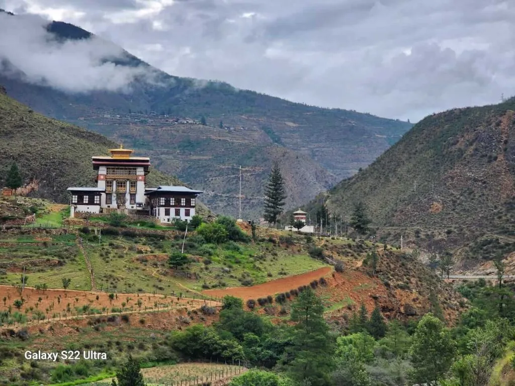 Dzong in a green mountain valley in Bhutan
