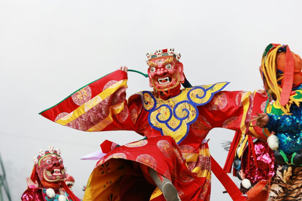 Dancer in brocade costume at Dochula Tshechu