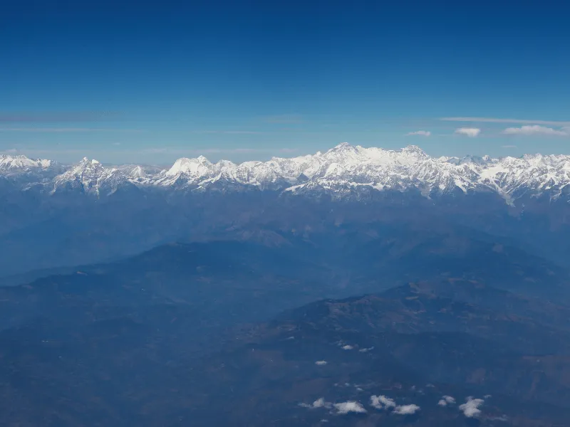 Snow-capped Himalayan range above the clouds seen from Bhutan